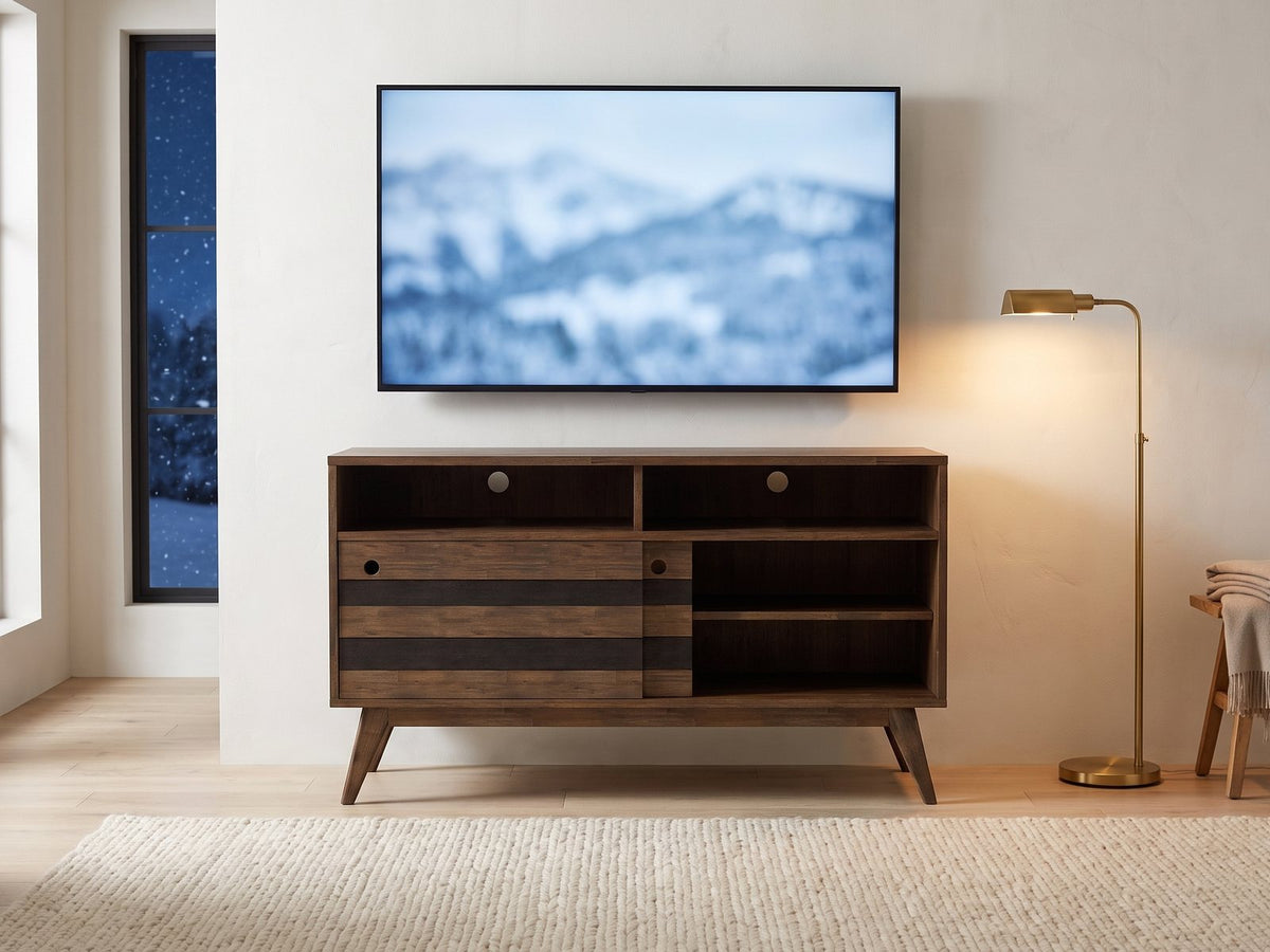 Offida Two-Tone Acacia Media Console under a screen showing a snowy landscape on a winter evening
