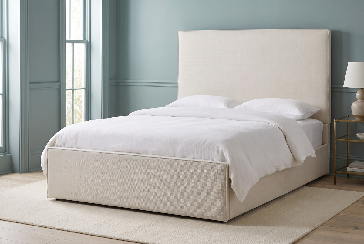 Penne ivory canvas bed against a dusty blue-green panelled wall in a Charleston townhouse bedroom with tall windows and a cream wool rug