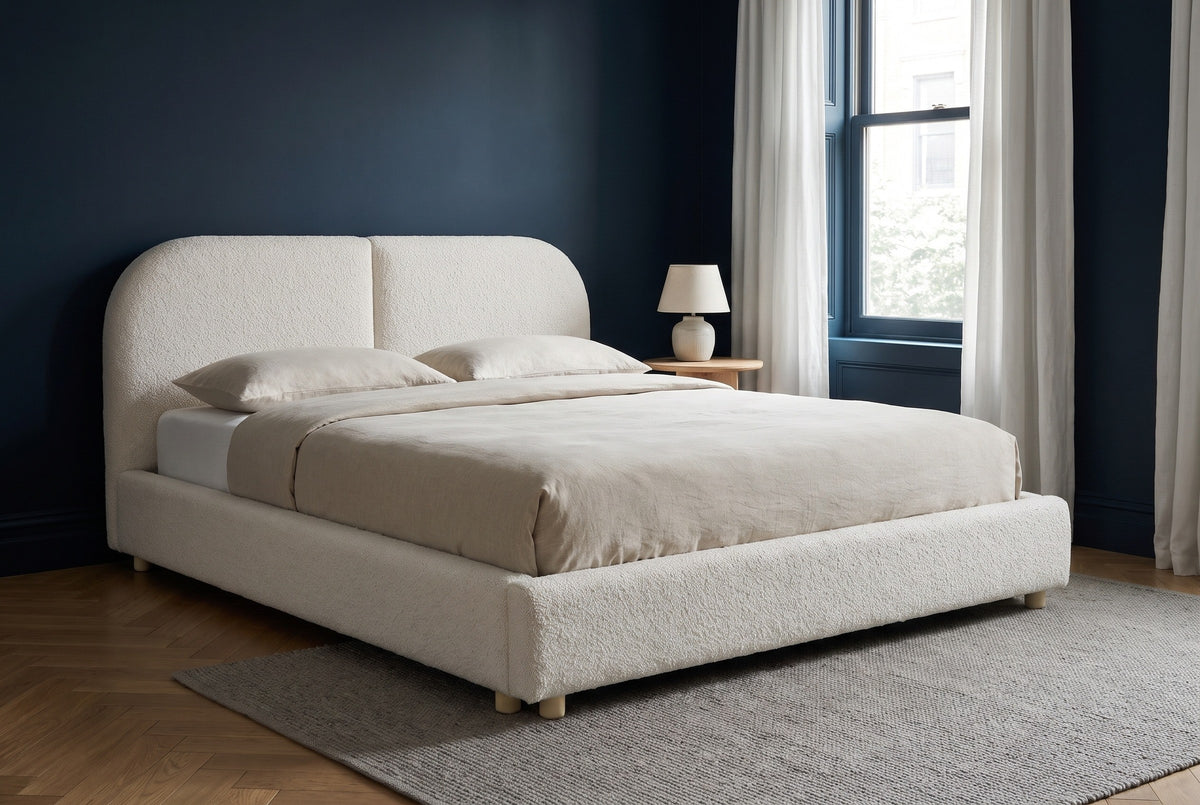 Pietrabbondante bed against a deep ink navy wall in a Brooklyn brownstone bedroom with a herringbone oak floor