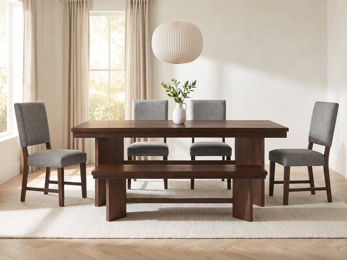 Pizzo 76-Inch Walnut Veneer Extending Trestle Dining Set with Bench and 4 Chairs in a bright plaster dining room with linen curtains