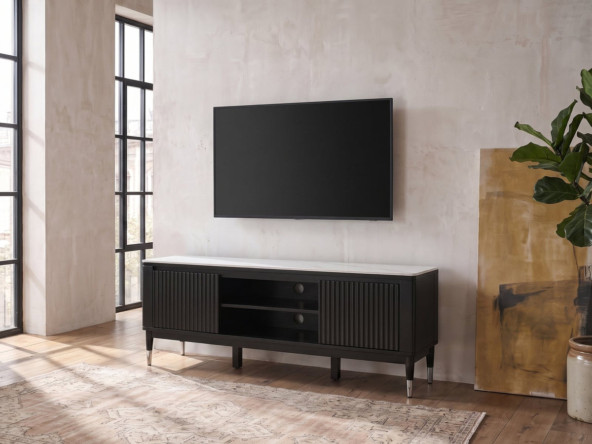 Ragusa Stone Top Media Console seen from the side, under a wall-mounted screen in an industrial loft