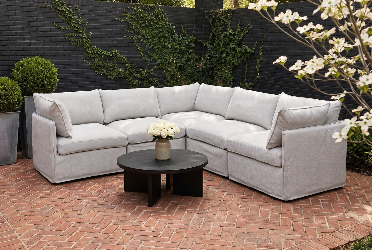 Randazzo light grey L-shaped sectional on a herringbone brick terrace in Atlanta, Georgia, against a black-painted brick wall with creeping fig (coffee table not included)