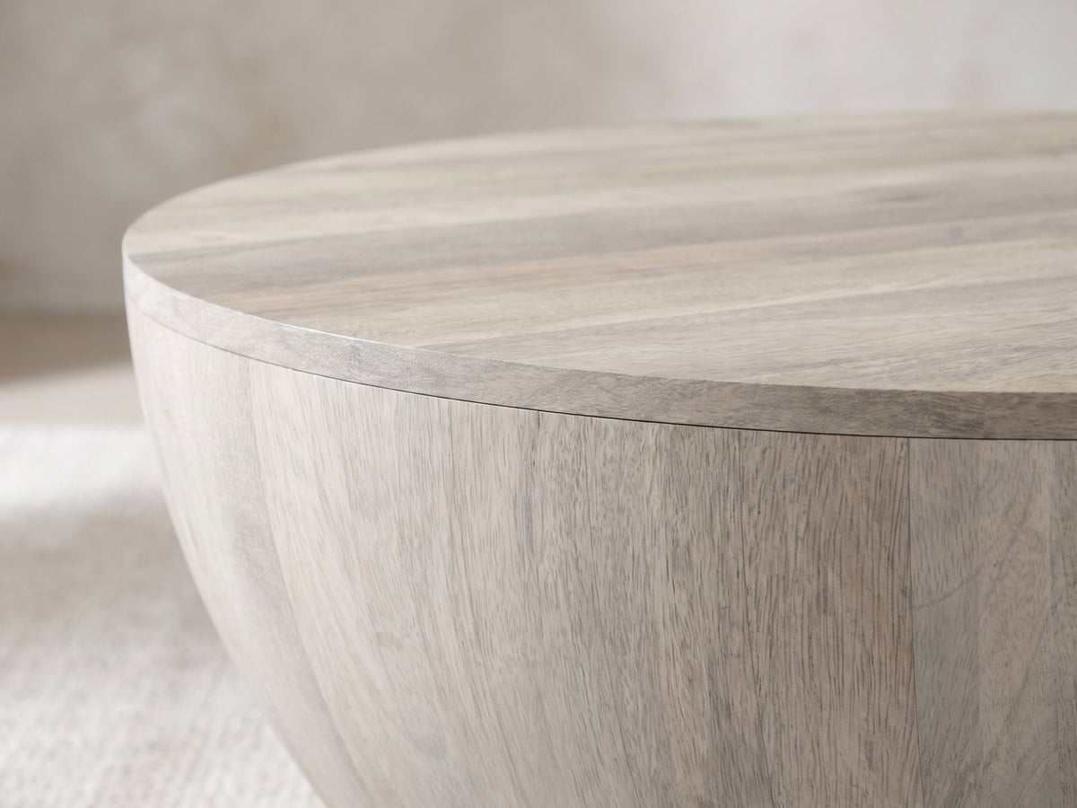 Close-up of the Rapallo Whitewashed Mango Bowl Coffee Table: the curved whitewashed mango body under the round top