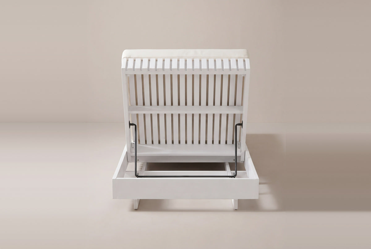 The Riesi chaise from behind the head end: the slatted back raised on a black metal prop bar above the open white head box