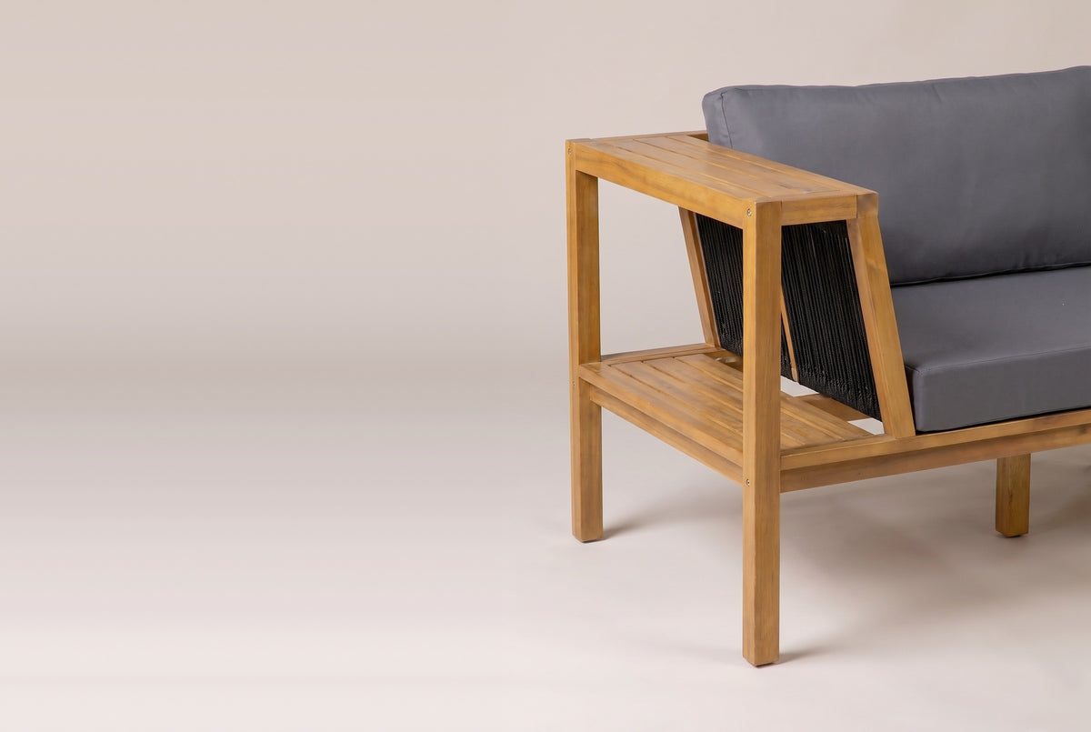 One end of the Riposto daybed sofa: the open box arm with its slatted top, the lower shelf and the slanted rope panel
