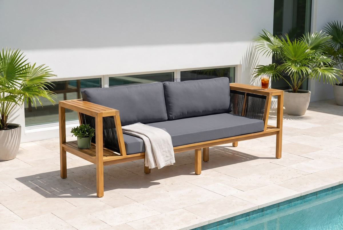 Riposto acacia daybed sofa on a travertine pool terrace at a modern house in Sarasota, white stucco wall and potted palms behind (throw and plant not included)