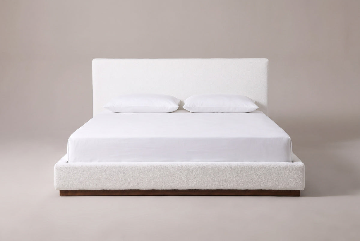 Roccascalegna bed in white boucle with a white mattress and pillows (not included), front view