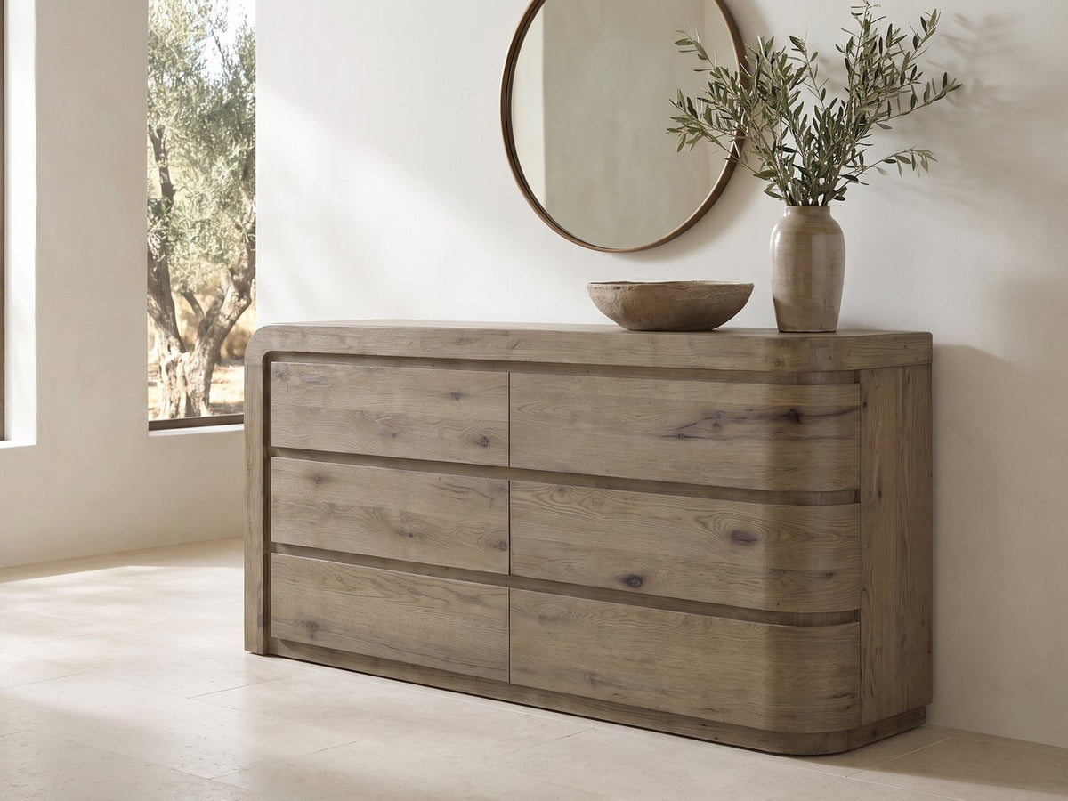 Sacile 70-Inch Weathered Natural Oak 6-Drawer Dresser under a round bronze mirror in a villa bedroom