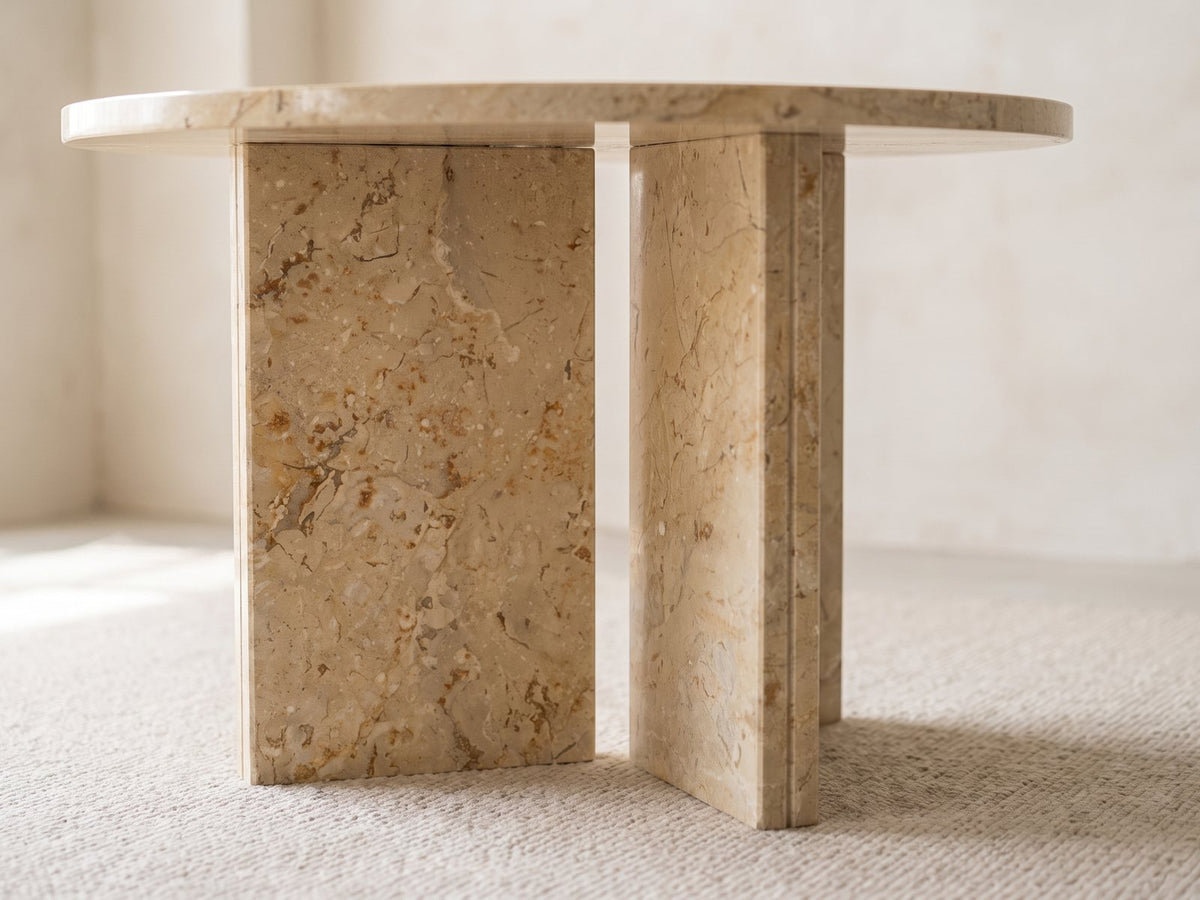 Close-up of the Salina Gold Beige Marble Round Side Table: the two gold beige marble slabs of the base set in a T under the top