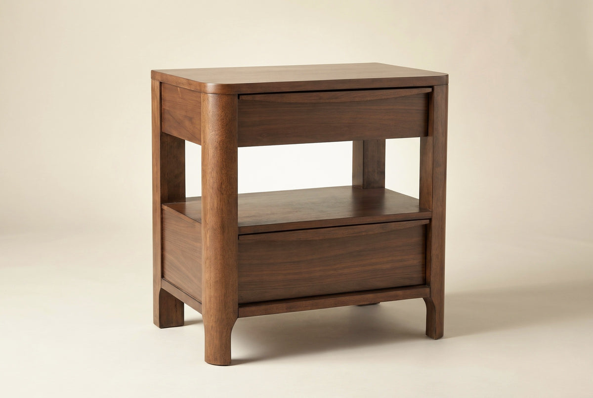 The Sanluri two-drawer nightstand in walnut veneer with an open shelf between the drawers, three-quarter view on a light studio backdrop