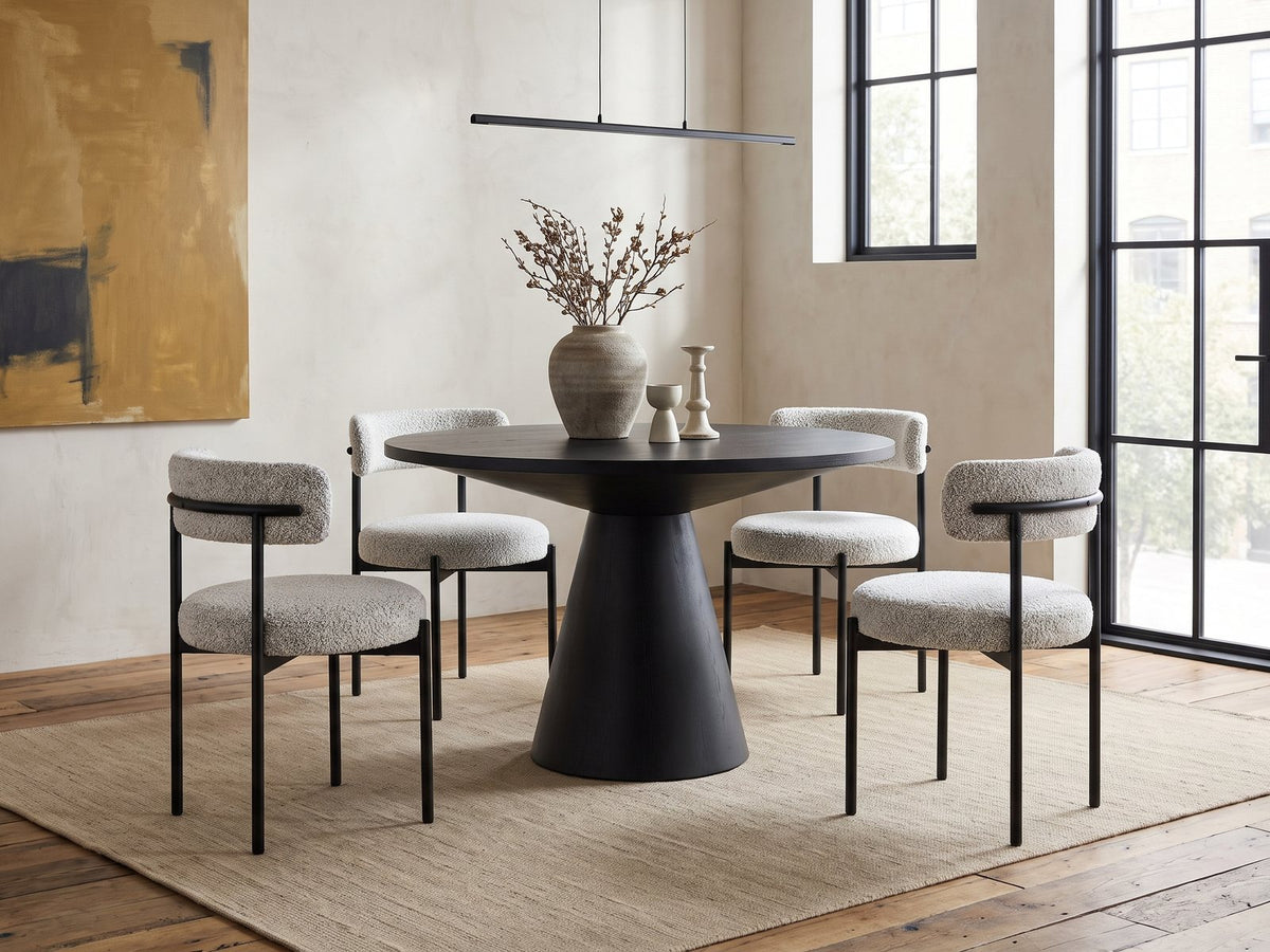 Savelli 47-Inch Round Black Oak Pedestal Dining Set with 4 Boucle Chairs in an industrial loft dining area