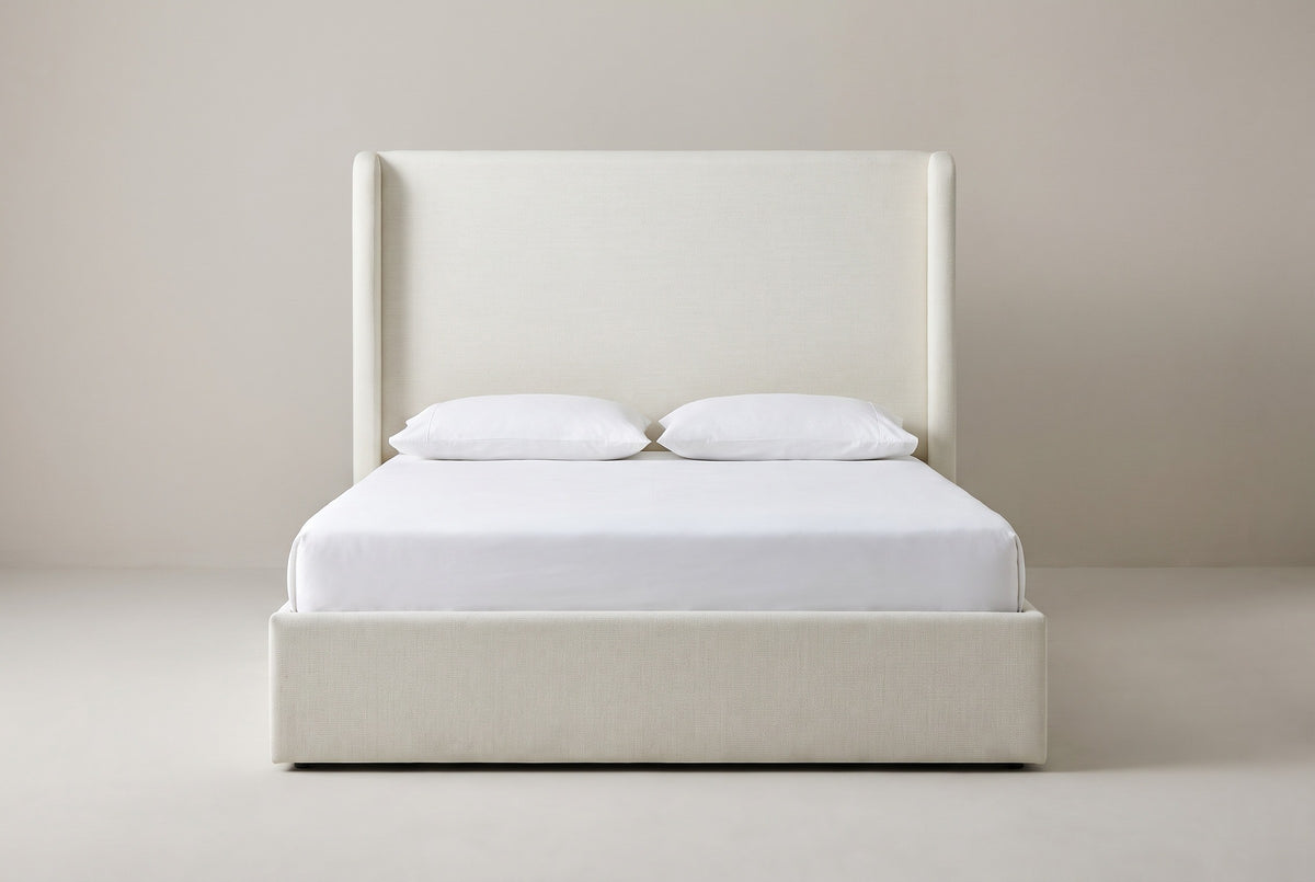 Scanno ivory canvas wingback bed with a white mattress and pillows (not included), front view