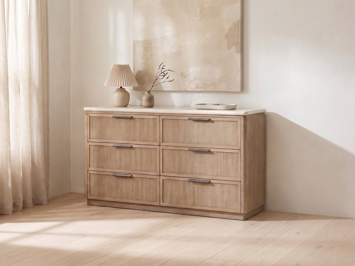 Schio 66.5-Inch Toffee 6-Drawer Dresser against a plaster wall under an abstract canvas in a bright bedroom