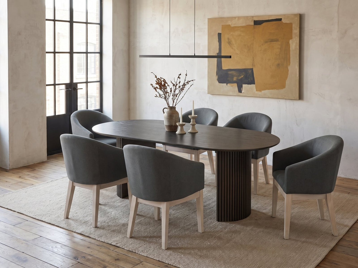 Seminara 80-Inch Oval Fluted Pedestal Dining Set with 6 Chairs in an industrial loft dining area