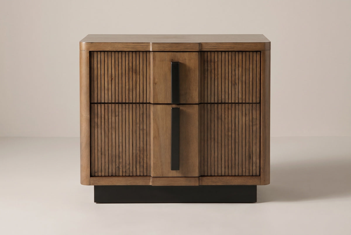 The Senorbi nightstand in ash brown with reeded drawer fronts, front view on a light studio backdrop