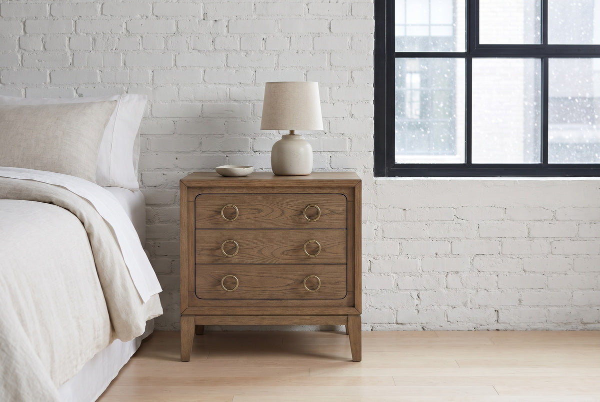 Serramanna latte elm nightstand against a white painted brick wall in a Minneapolis loft bedroom on a snowy morning