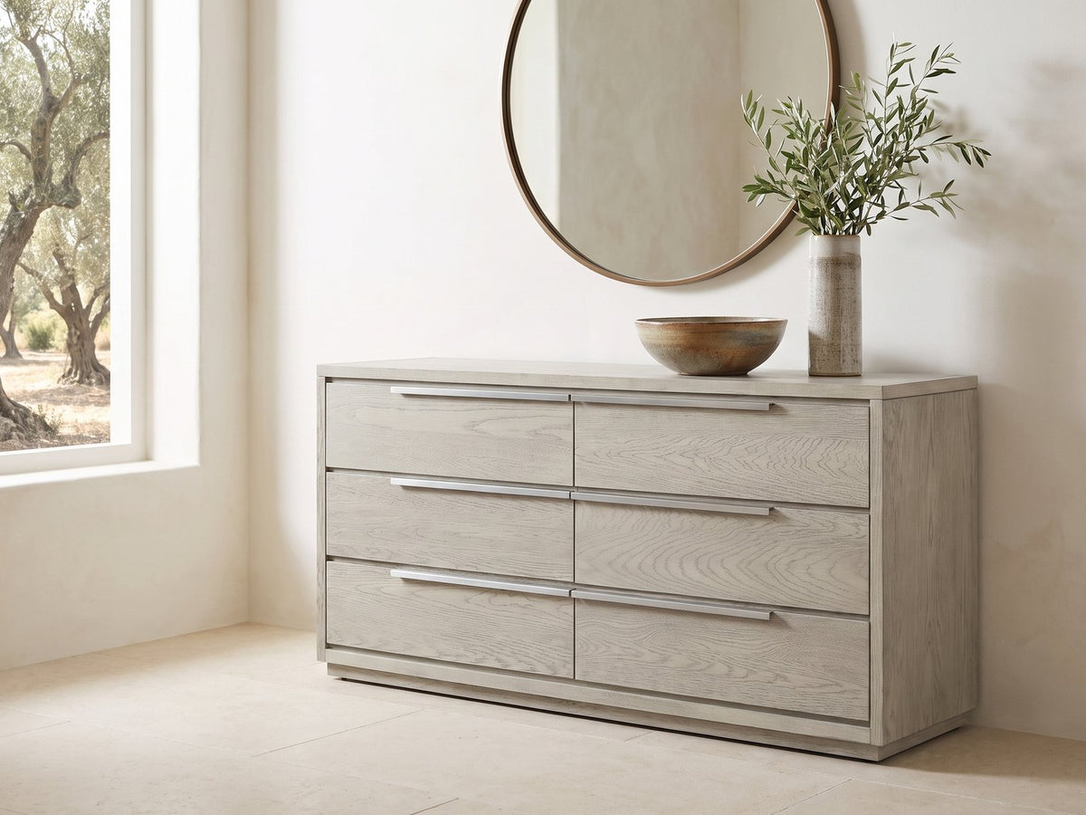 Sesto 63-Inch Gray Oak 6-Drawer Dresser under a round bronze mirror in a villa bedroom