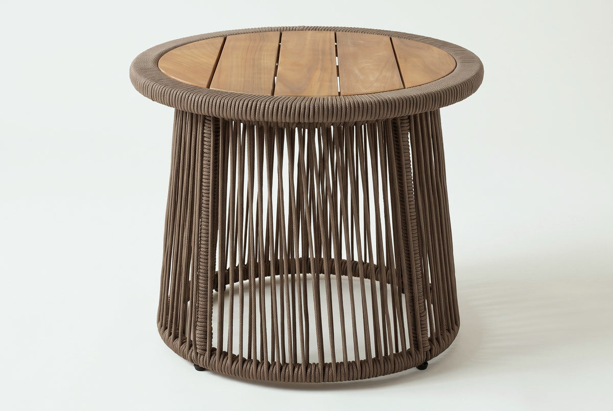The Siculiana side table, three-quarter view: a round slatted acacia top in a thick rope rim over an open cone of dark beige rope, on a light studio backdrop
