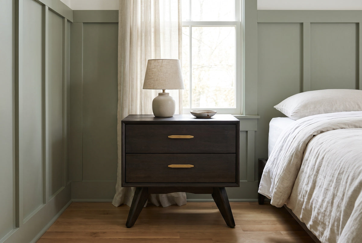 Siniscola dark acacia nightstand with a ceramic lamp in a Nashville bedroom with sage-green board-and-batten walls and oak floors