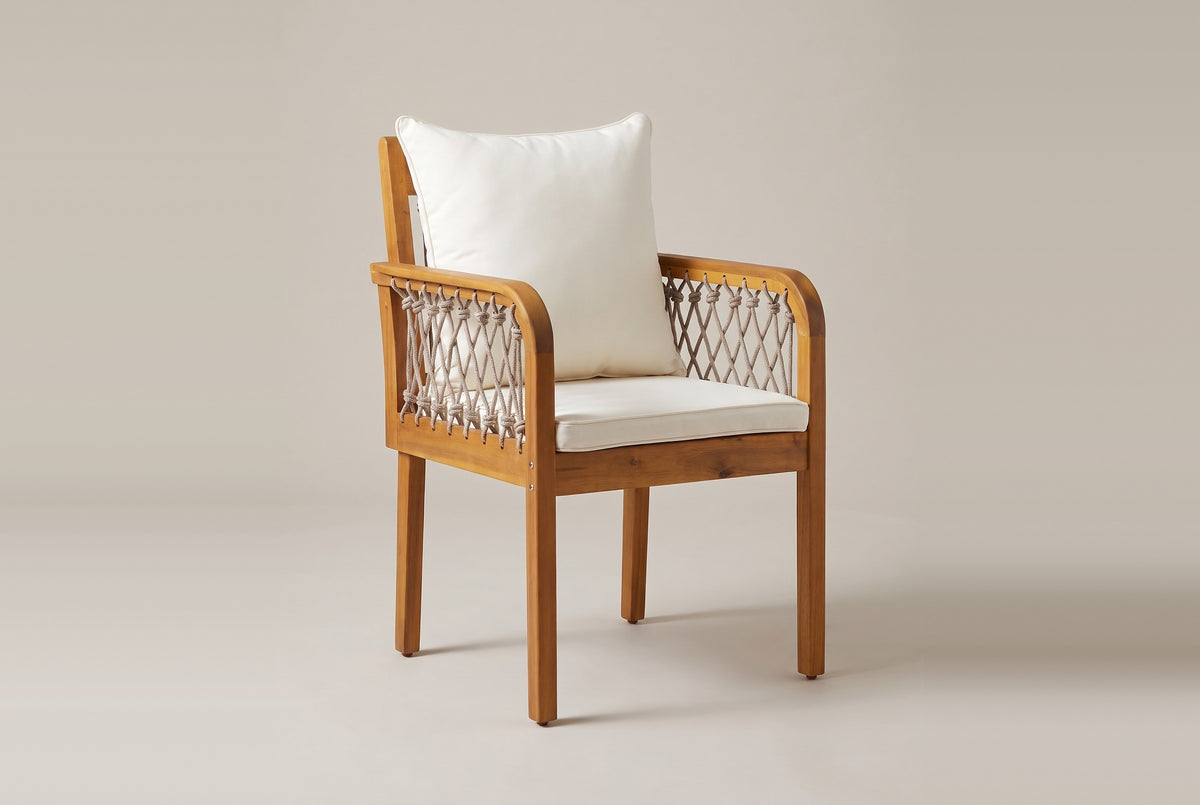 One Siracusa armchair from the front three-quarter view: rope sides and back, rounded arm fronts, ivory seat and back cushions