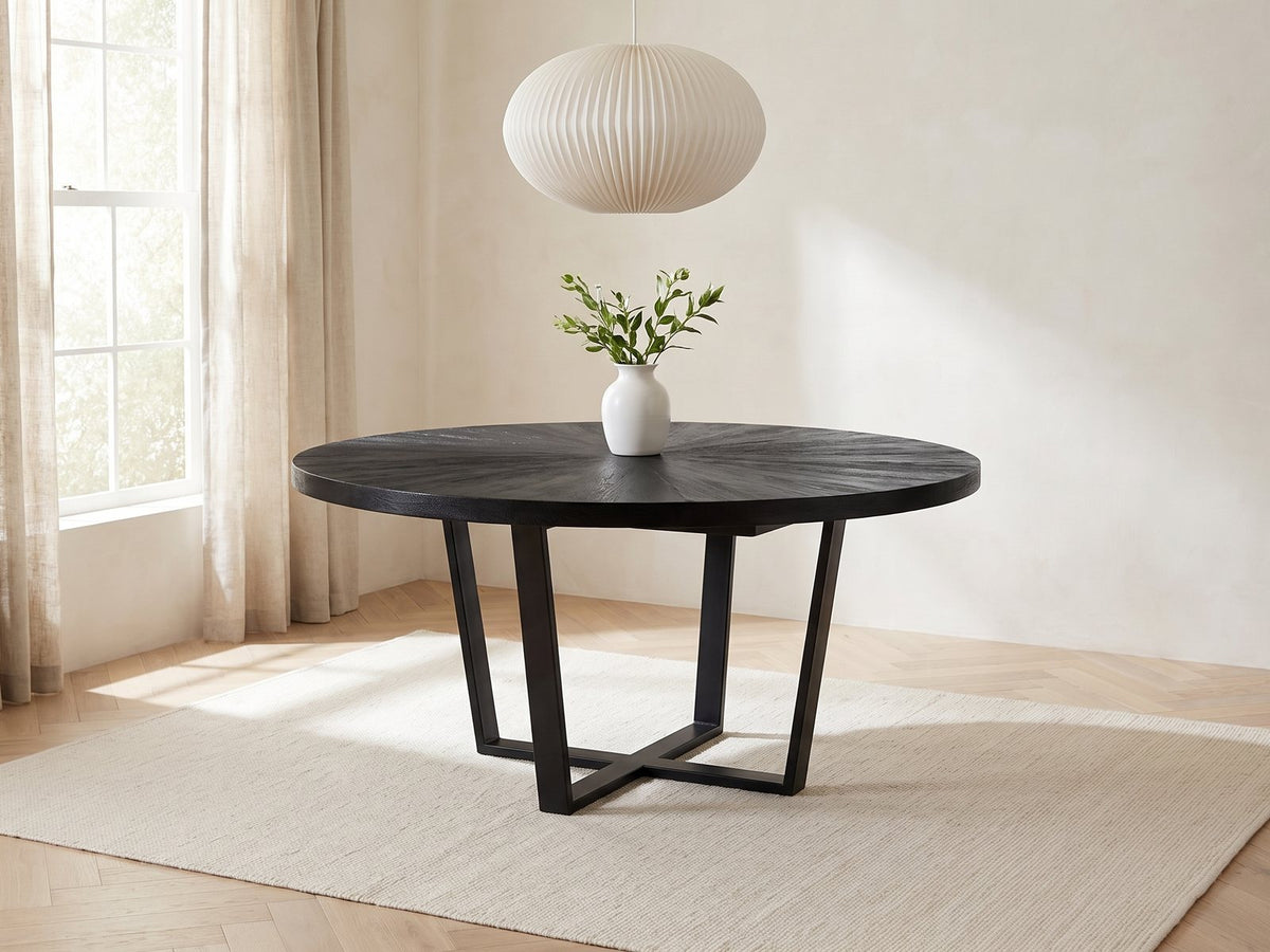 Soveria 63-Inch Round Black Acacia Sunburst Dining Table in a bright plaster dining room with linen curtains