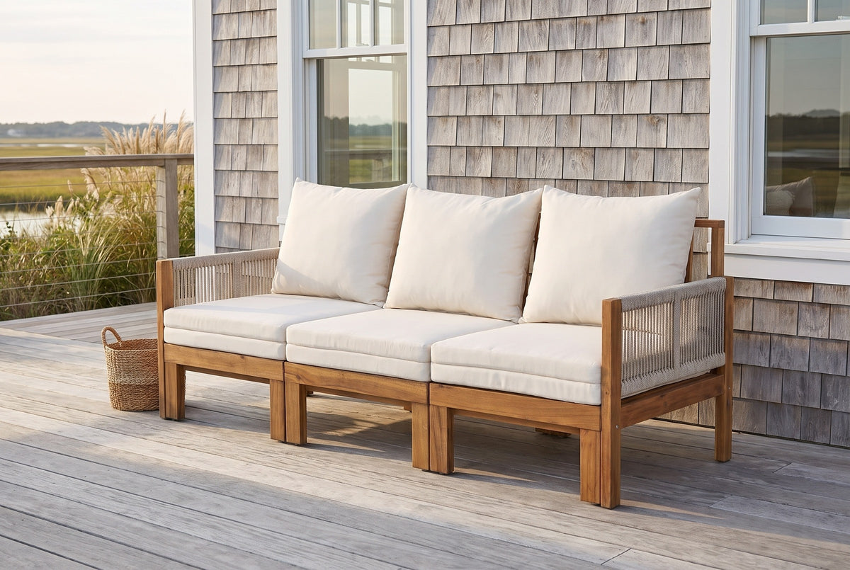 Sperlinga sofa on a Hilton Head beach-house deck with a silver cedar-shingle wall, white windows and a marsh view (basket not included)