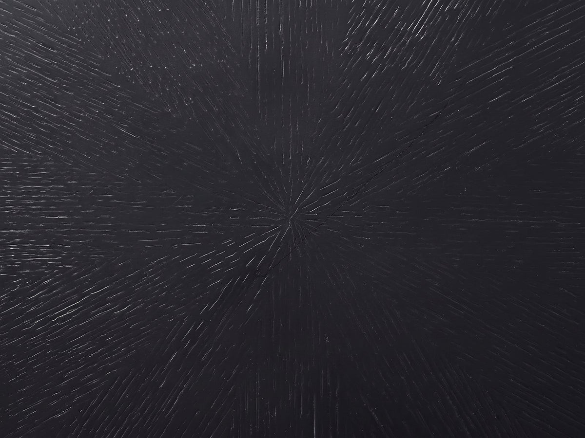 Close-up of the Spilimbergo Black Fiberglass Twisted Petal Side Table: the radial brushed sunburst texture of the black top