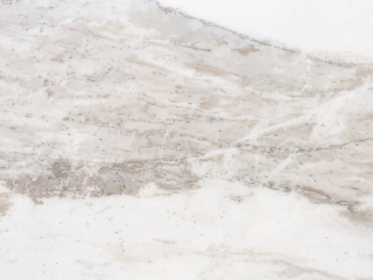 Close-up of the Stintino White Marble Round Side Table: the veining of the semi-polished white marble top