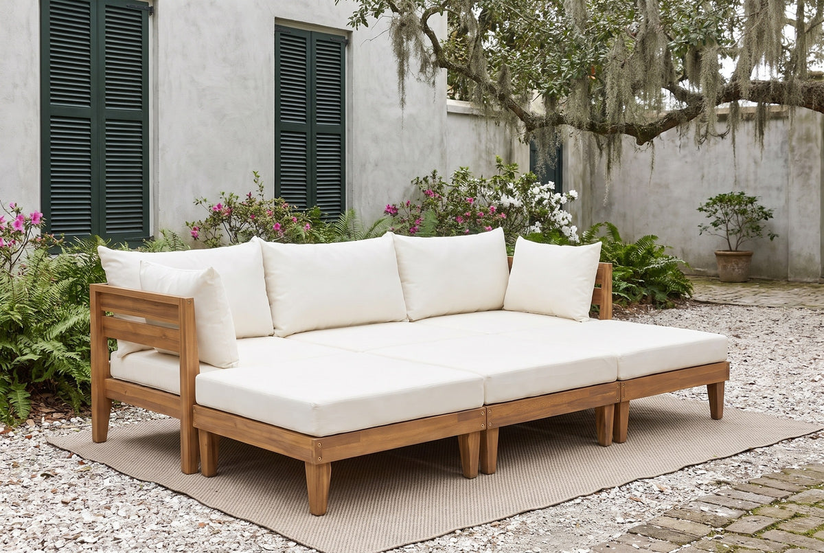 Stromboli acacia daybed set in a Savannah, Georgia courtyard with grey stucco walls, dark green shutters, a live oak with Spanish moss and an oyster-shell floor (rug and plants not included)