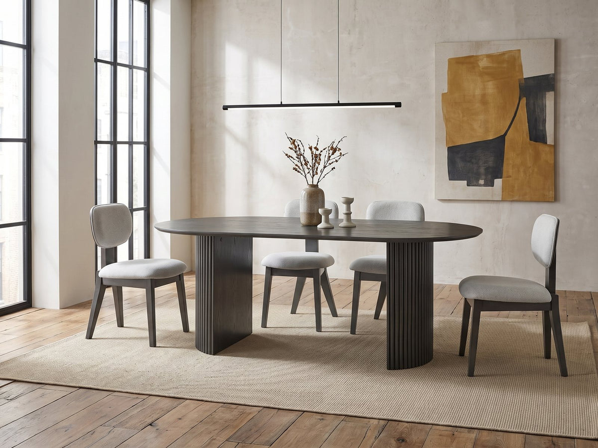 Strongoli 80-Inch Oval Fluted Pedestal Dining Set with 4 Chairs in an industrial loft dining area
