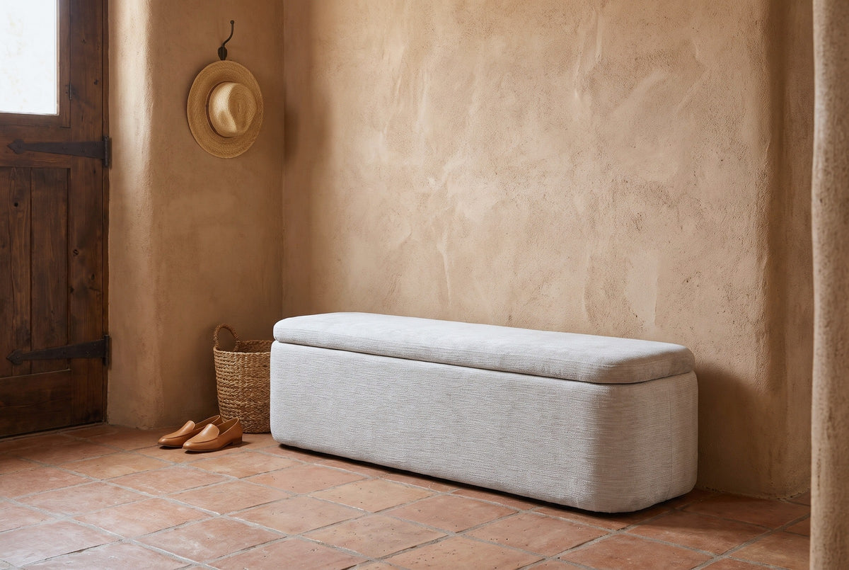 Subiaco gray storage bench against a rough sand-terracotta adobe wall in a Santa Fe entry with a terracotta tile floor, a seagrass basket and a pair of loafers