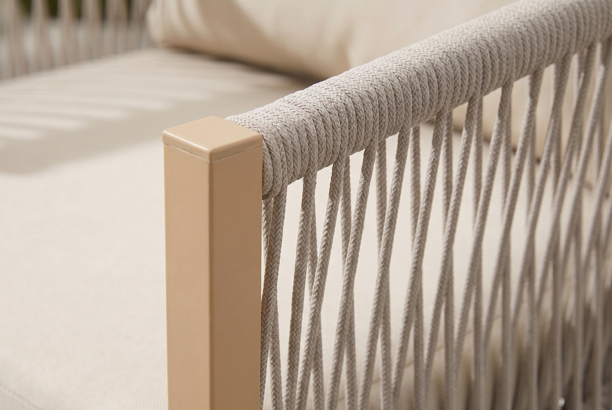 Close-up of the Sutera chair: braided rope wrapped round the top rail beside a sand-colored aluminum post