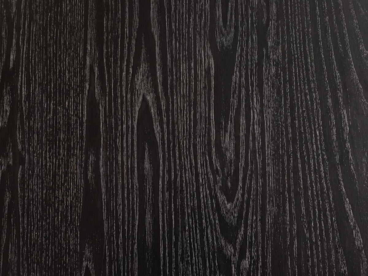 Close-up of the Taranto Black Faceted Drum Coffee Table: the open-pore black wood grain of the octagonal top