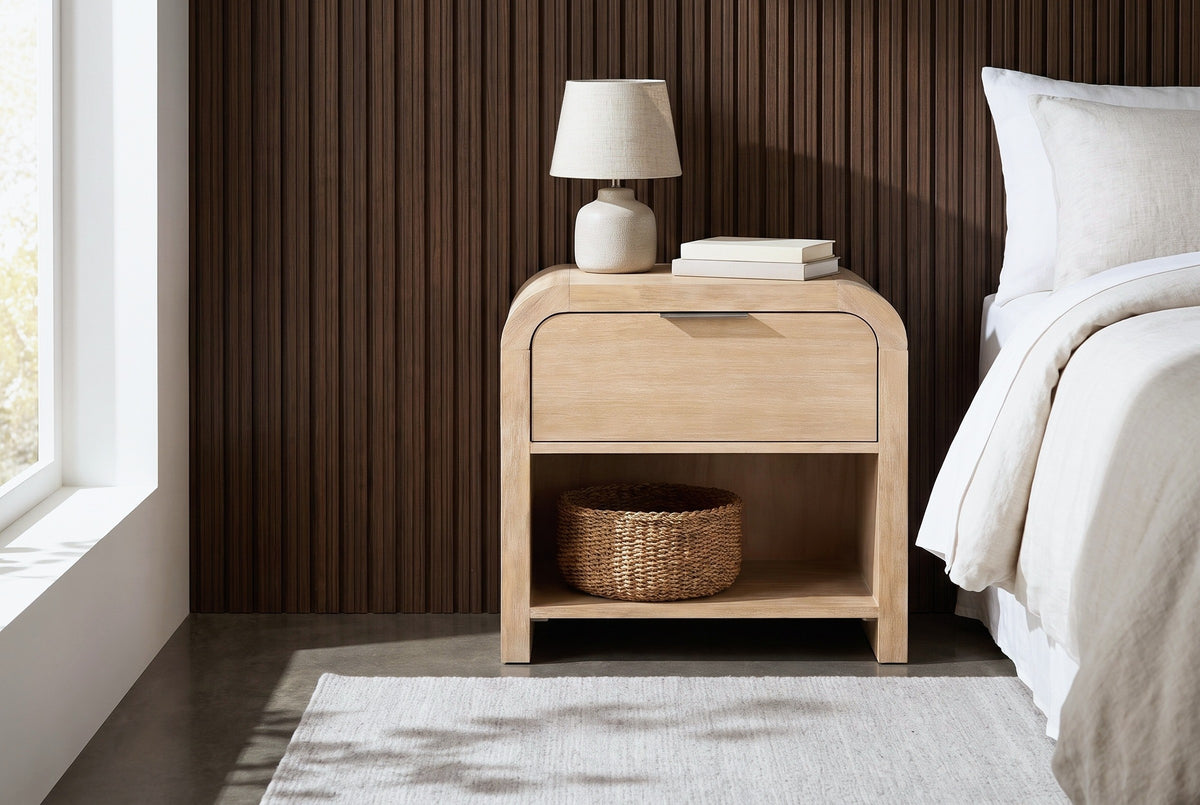 Tempio natural mango waterfall nightstand with a ceramic lamp and a seagrass basket beside a bed in a Denver bedroom with a dark walnut slat wall