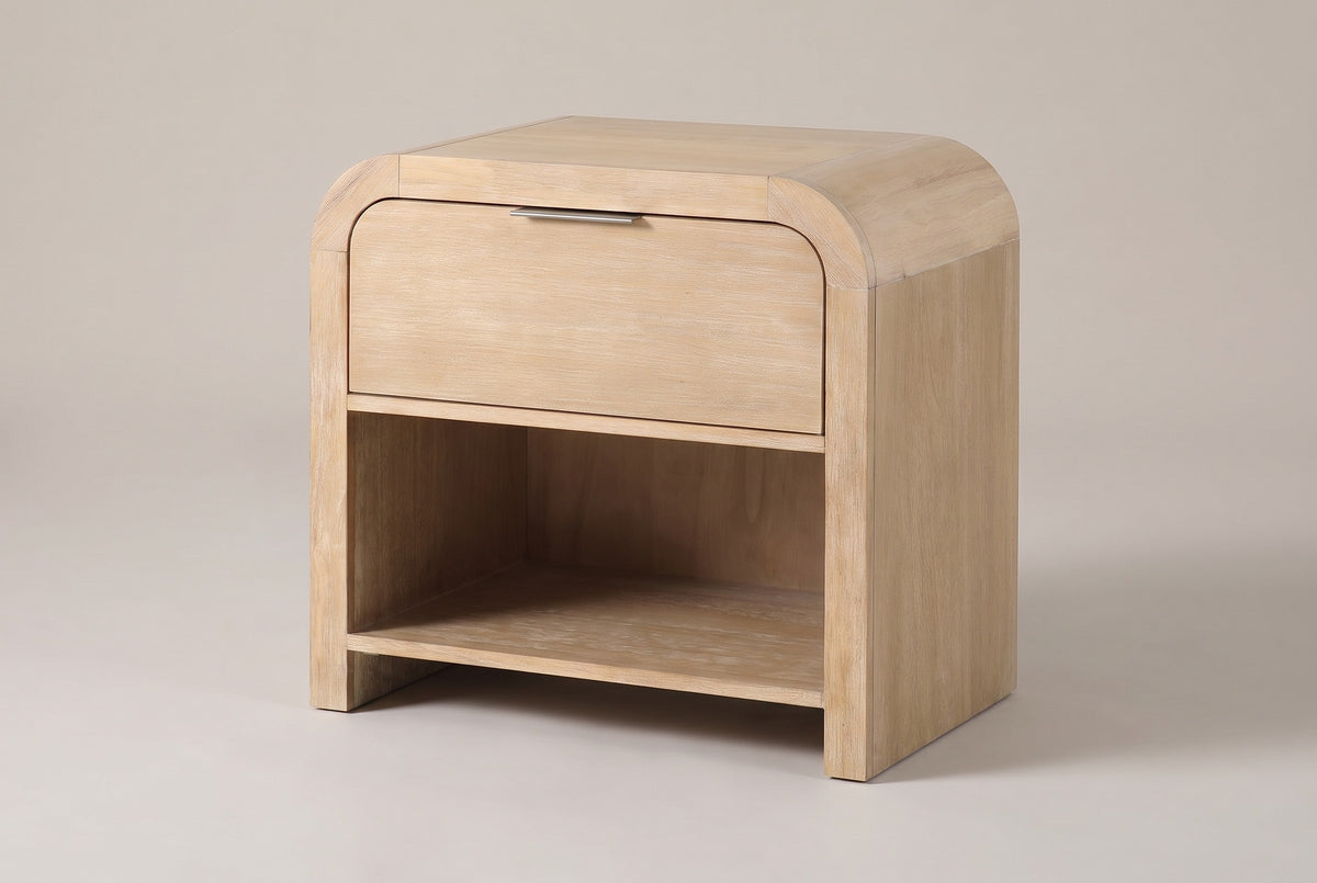 The Tempio waterfall nightstand in natural mango veneer, three-quarter view on a light studio backdrop