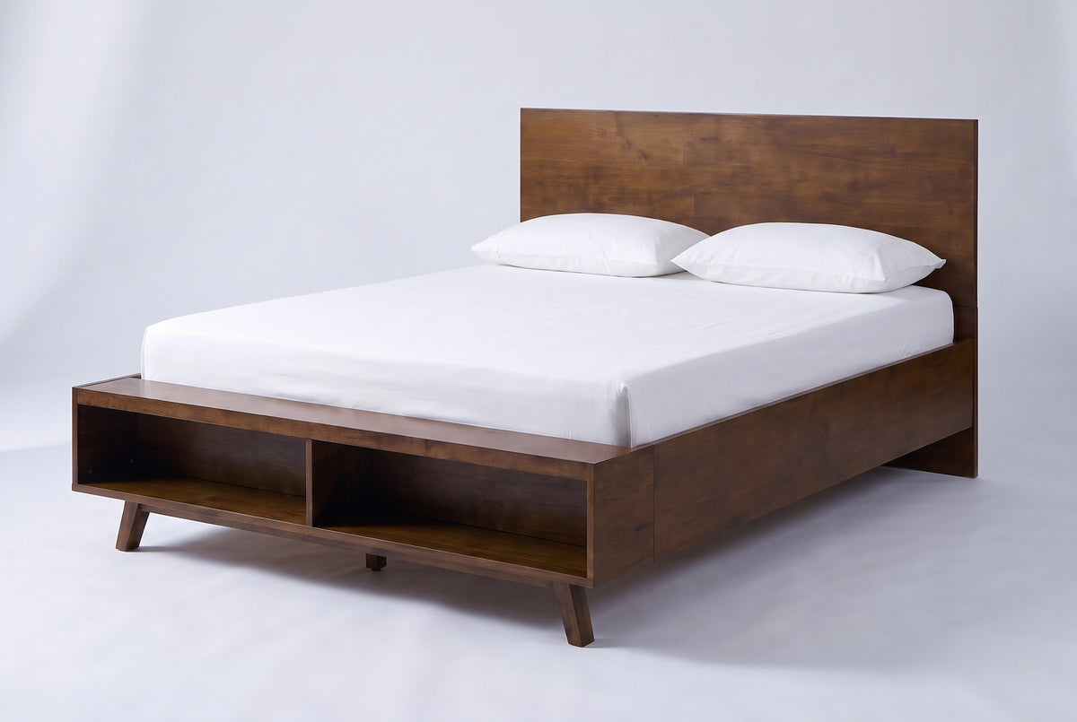The Termoli bed in walnut-stained rubberwood with a white mattress and pillows (not included), three-quarter view on a light studio backdrop