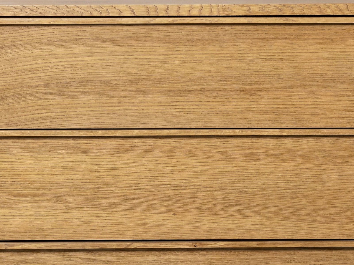 Close-up of the Tolmezzo 72-Inch Natural Oak 6-Drawer Dresser: the straight white oak grain of the drawer fronts and a solid oak finger lip