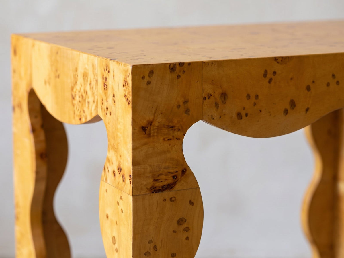 Close-up of the Tricarico Burl Veneer Scalloped Side Table: the scalloped apron and a wavy burl veneer leg