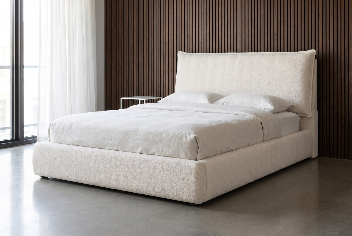 Trivento cream white chenille bed against dark walnut slat panelling in a Chicago loft bedroom with a polished concrete floor and a tall window
