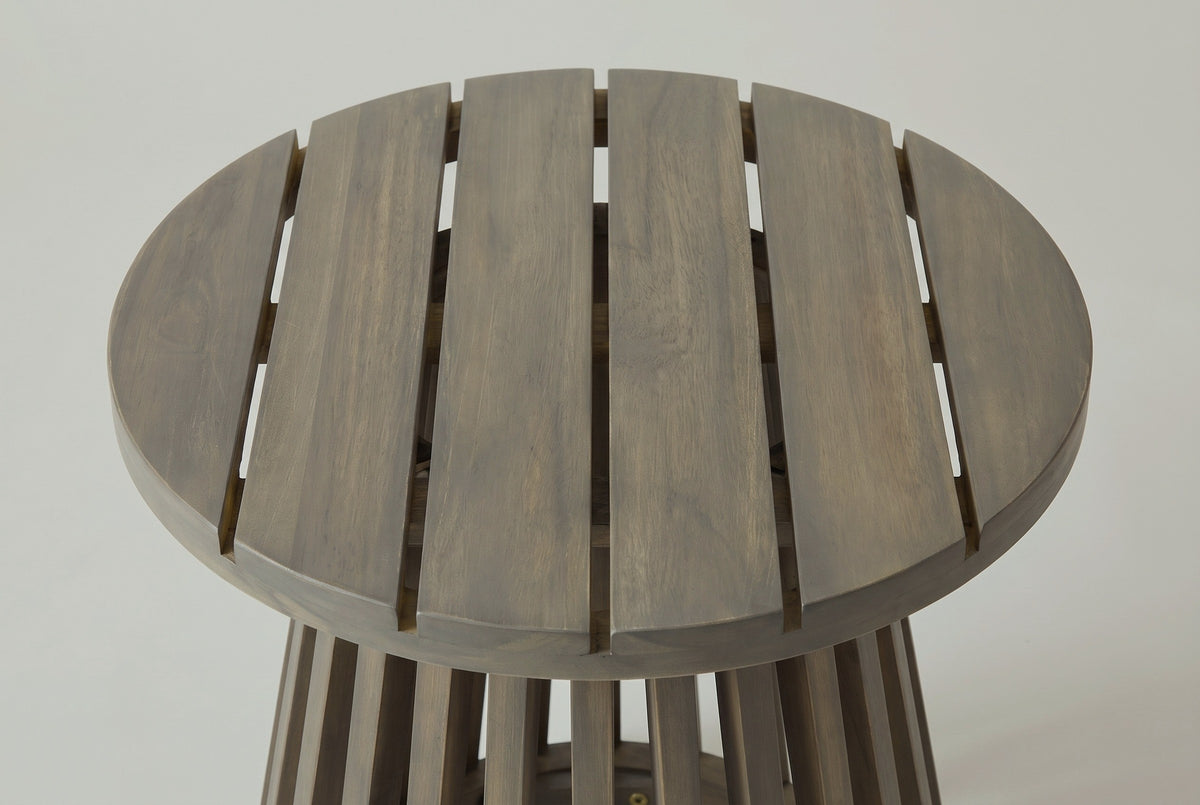 The Valderice side table seen from above: the round top of six acacia slats with narrow gaps, the slatted base just showing below
