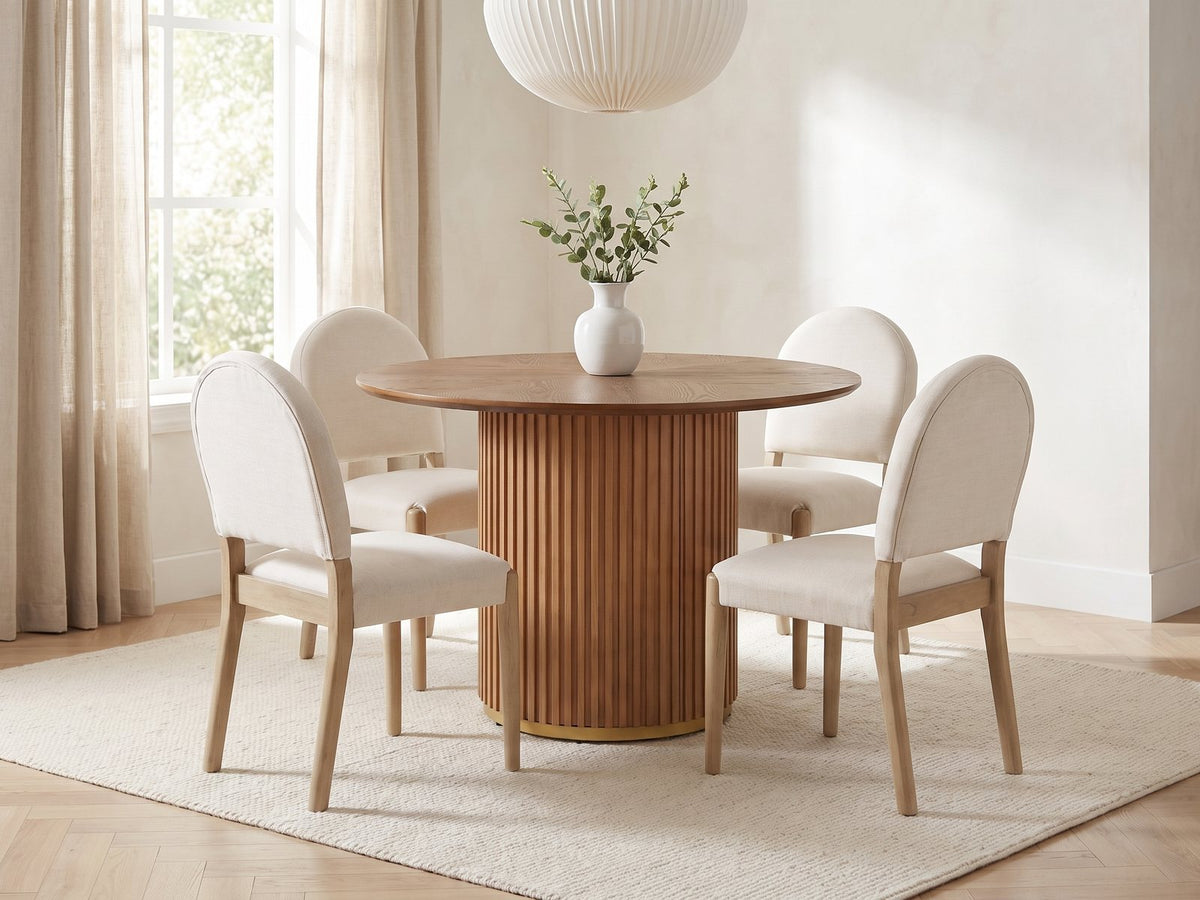 Veroli 47-Inch Round Fluted Pedestal Dining Set with 4 Chairs in a bright plaster dining room with linen curtains