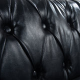 Close-up of the black PU upholstery and button tufting