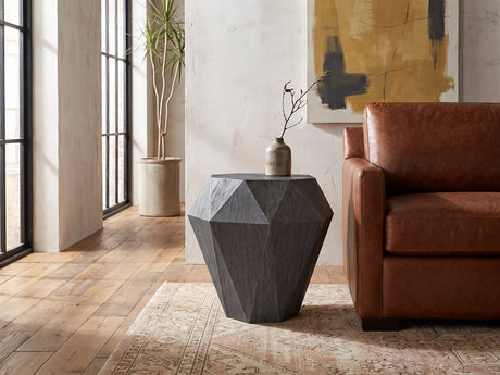 Accadia Grey Mango Faceted Octagon Side Table beside a cognac leather armchair in an industrial loft