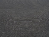 Close-up of the Accadia Grey Mango Faceted Octagon Side Table: the grey-washed mango grain of the octagonal top