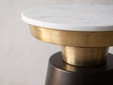 Close-up of the Acerenza White Marble Pedestal Side Table: the marble top on the gold-tone tray, stem and black cone