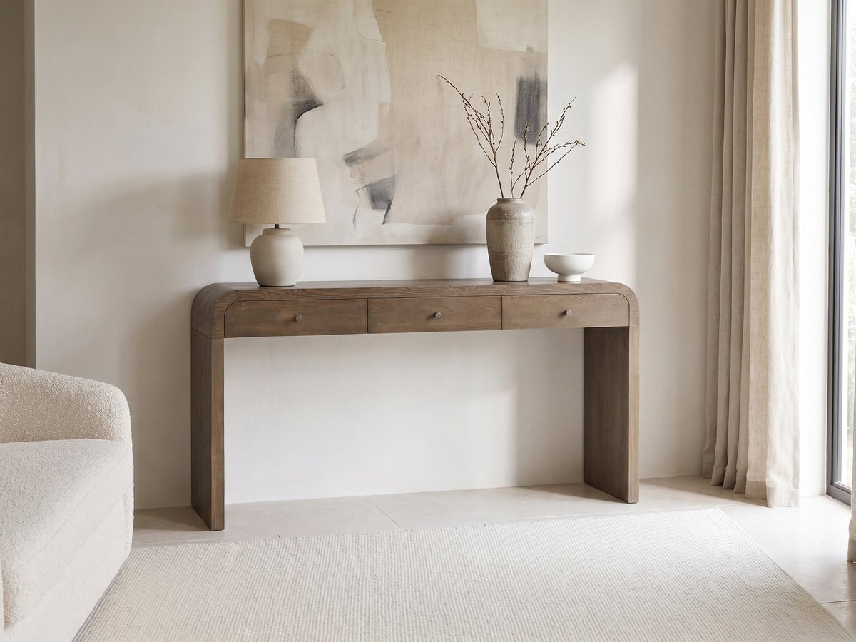 Adelfia Ash Veneer Waterfall Console Table against a plaster wall under an abstract canvas in a bright living room
