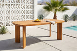 Adrano acacia dining table on pale concrete pavers by a pool in Palm Springs, a white breeze-block screen wall, a fan palm, agaves and the mountains behind (chairs not included)