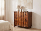 Adria 34-Inch Chestnut Solid Mango 3-Drawer Chest against a plaster wall under an abstract canvas in a bright bedroom