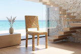 Aieta Parsons Seagrass-Wrapped Dining Chair in an oceanfront glass house
