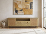 Alassio 80-Inch Sand Wash Ash and Rattan Media Console under a large abstract painting in a bright living room